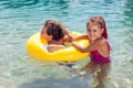 Kids on beach with swimming circle. Children and holiday concept Royalty Free Stock Photo