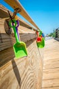 Kids beach toys hanging on boardwalk entrance to the beach Royalty Free Stock Photo