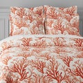 Printed orange and white bed sheets and pillows. Royalty Free Stock Photo