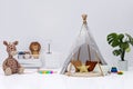 Kids bedroom with stuffed toy animals and play teepee. Royalty Free Stock Photo