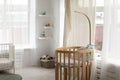 Kids bedroom with wooden bassinet for newborn infant