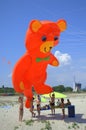 Kids and big orange bear kite