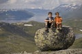 Kids on big stone in mountains