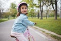 Kids, bike and learning to ride with a girl in the park on her bicycle while wearing a helmet for safety outdoor. Summer Royalty Free Stock Photo