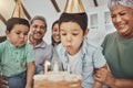 Kids, birthday cake and kid blowing candles at a house at a party with food and celebration. Children, celebrate event Royalty Free Stock Photo