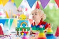 Kids birthday party. Child blowing out cake candle Royalty Free Stock Photo