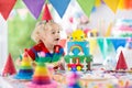 Kids birthday party. Child blowing out cake candle Royalty Free Stock Photo