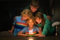 Kids birthday party. Child blowing out cake candle Royalty Free Stock Photo