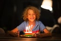 Kids birthday party. Child blowing out cake candle Royalty Free Stock Photo