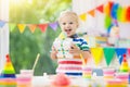 Kids birthday party. Child blowing out cake candle Royalty Free Stock Photo