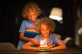 Kids birthday party. Child blowing out cake candle Royalty Free Stock Photo