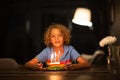 Kids birthday party. Child blowing out cake candle Royalty Free Stock Photo