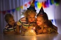 Kids birthday party. Children blow cake candles. Royalty Free Stock Photo