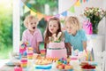 Kids birthday party. Children blow cake candles. Royalty Free Stock Photo