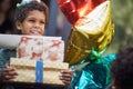 Kids birthday party . Little boy in birthday cap holding pile of birthday presents Royalty Free Stock Photo