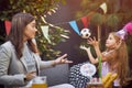 Kids birthday party . Little girl in birthday cap holding pile of birthday presents Royalty Free Stock Photo