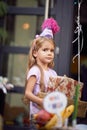 Kids birthday party . Little girl in birthday cap holding pile of birthday presents Royalty Free Stock Photo