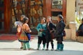 Kids of the Black Miao Hmong minority hill tribe wearing traditional costumes talk at the street in Sapa, Vietnam.