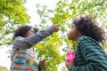 Kids playing with friends Blowing Bubbles Royalty Free Stock Photo