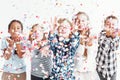 Kids blowing confetti Royalty Free Stock Photo