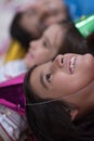 Kids blowing confetti while lying on the floor Royalty Free Stock Photo