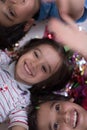 Kids blowing confetti while lying on the floor Royalty Free Stock Photo