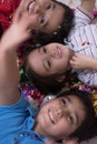 Kids blowing confetti while lying on the floor Royalty Free Stock Photo