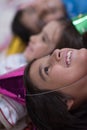 Kids blowing confetti while lying on the floor Royalty Free Stock Photo