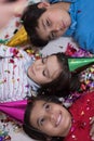 Kids blowing confetti while lying on the floor Royalty Free Stock Photo