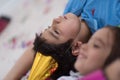 Kids blowing confetti while lying on the floor Royalty Free Stock Photo