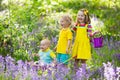 Kids in bluebell flower forest in summer