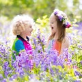 Kids with bluebell flowers, garden tools Royalty Free Stock Photo