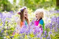 Kids with bluebell flowers, garden tools