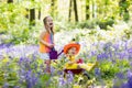 Kids with bluebell flowers, garden tools Royalty Free Stock Photo