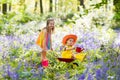 Kids with bluebell flowers, garden tools