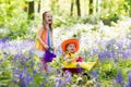 Kids with bluebell flowers, garden tools Royalty Free Stock Photo