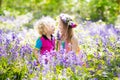 Kids with bluebell flowers, garden tools Royalty Free Stock Photo