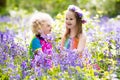 Kids with bluebell flowers, garden tools Royalty Free Stock Photo