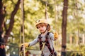 Kids boy adventure and travel. Cute school child boy enjoying a sunny day in a climbing adventure activity park. Cargo Royalty Free Stock Photo