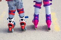 Kids boy and girl having fun outdoor while riding roller skates. Children on rollerblades. Roller skating in the park near Royalty Free Stock Photo