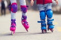 Kids boy and girl having fun outdoor while riding roller skates. Children on rollerblades. Roller skating in the park near Royalty Free Stock Photo