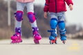 Kids boy and girl having fun outdoor while riding roller skates. Children on rollerblades. Roller skating in the park near Royalty Free Stock Photo