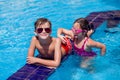 Kids boy and girl playing in the swimming pool. Childhood, summer and vacation concept Royalty Free Stock Photo