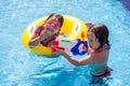 Kids boy and girl playing in the swimming pool. Childhood, summer and vacation concept Royalty Free Stock Photo