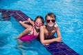 Kids boy and girl playing in the swimming pool. Childhood, summer and vacation concept Royalty Free Stock Photo