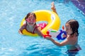 Kids boy and girl playing in the swimming pool. Childhood, summer and vacation concept Royalty Free Stock Photo