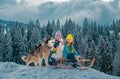 Kids boy and little girl with husky dog enjoying a sleigh ride. Children sibling together sledding, play outdoors in Royalty Free Stock Photo