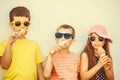 Kids boys and little girl eating ice cream. Royalty Free Stock Photo