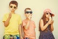 Kids boys and little girl eating ice cream. Royalty Free Stock Photo