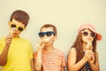 Kids boys and little girl eating ice cream. Royalty Free Stock Photo